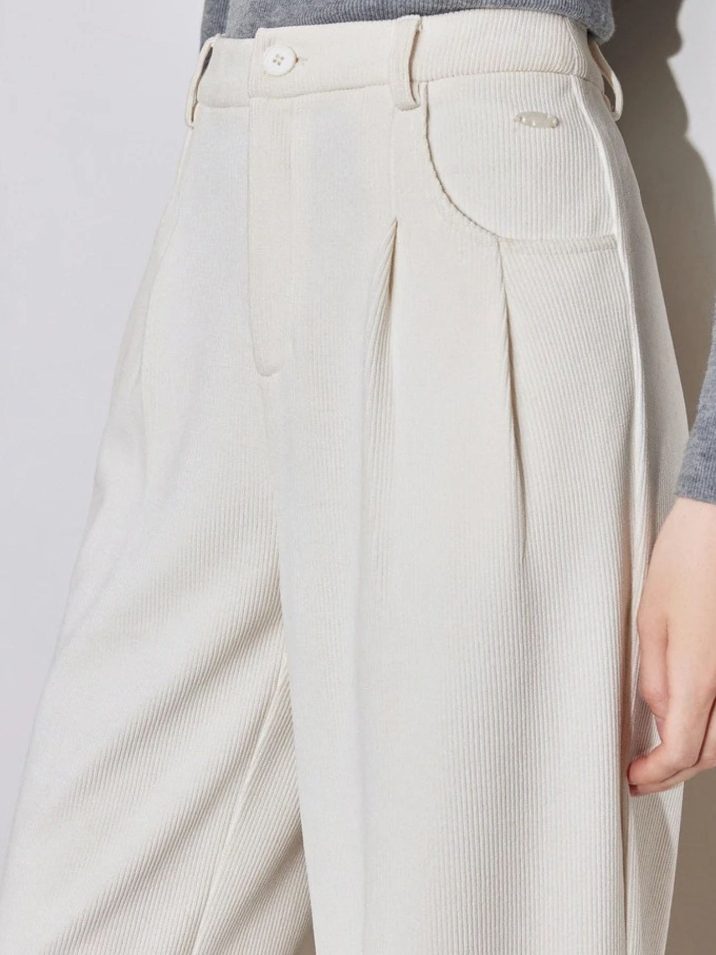 Close up of white corduroy pants
