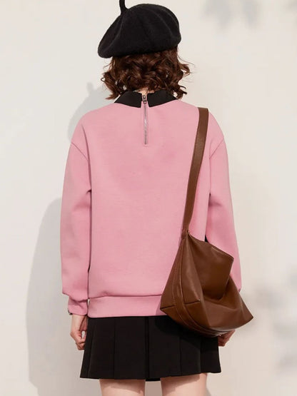 Back view of pink sweatshirt with plain design and long sleeves