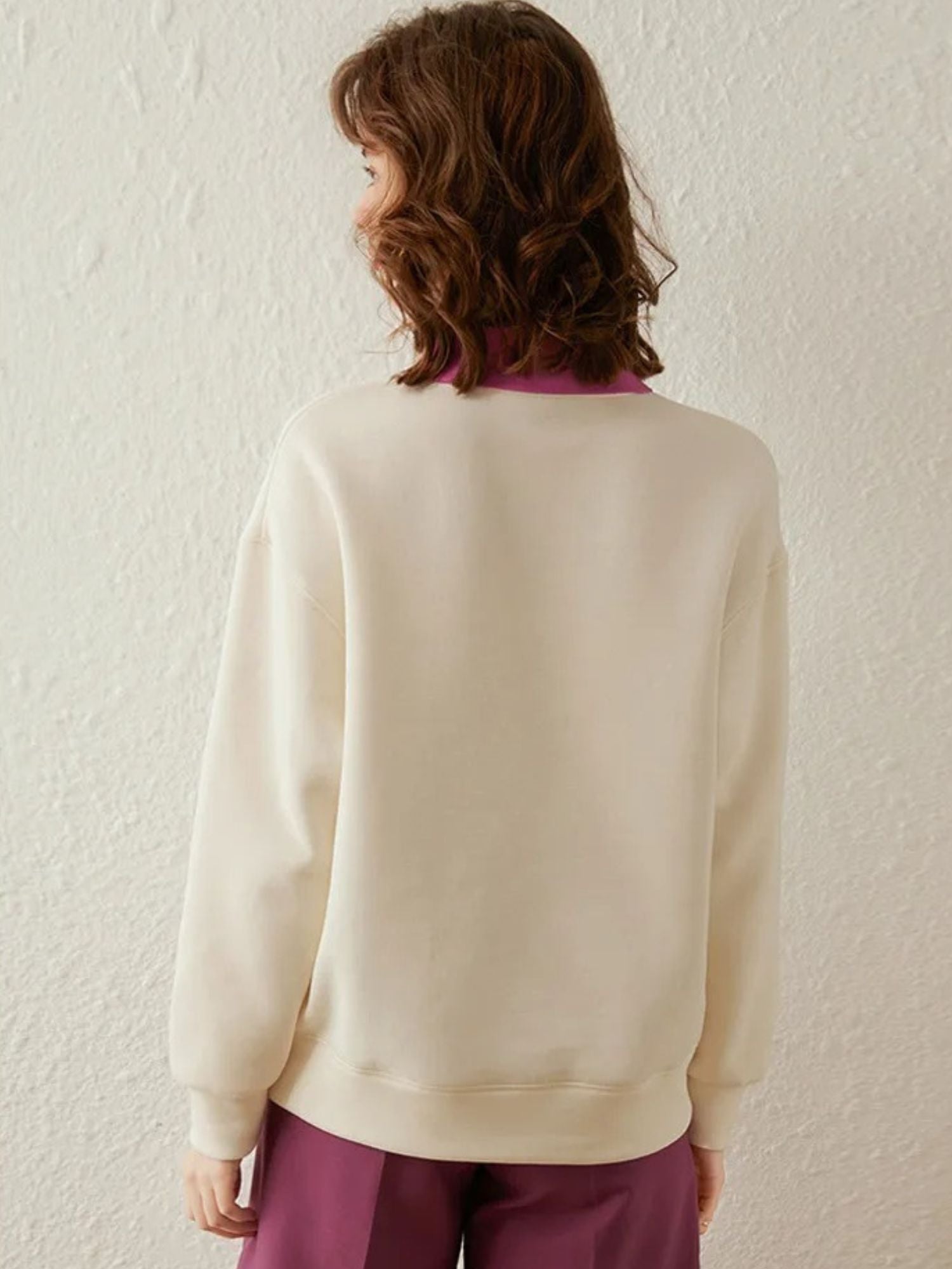 Back view of ivory sweatshirt with plain design and long sleeves