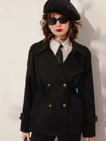 Woman wearing a black double-breasted blazer with gold buttons, white shirt, black tie, beret, and sunglasses