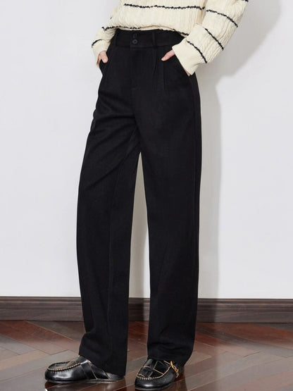 Side view of black wide-leg trousers styled with striped sweater and loafers