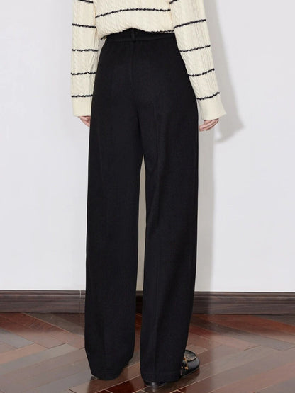 Back view of black wide-leg trousers styled with striped sweater and loafers