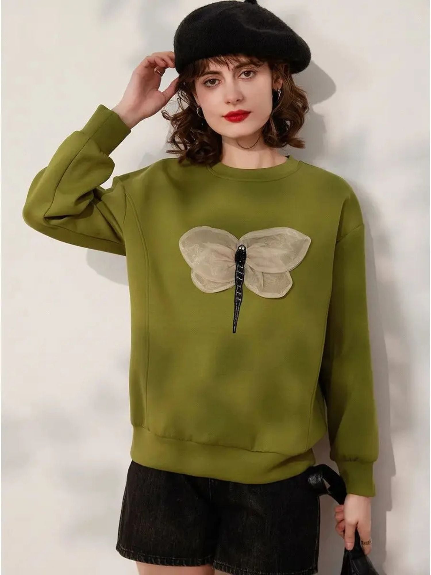 Front view of green butterfly embroidered sweatshirt with long sleeves