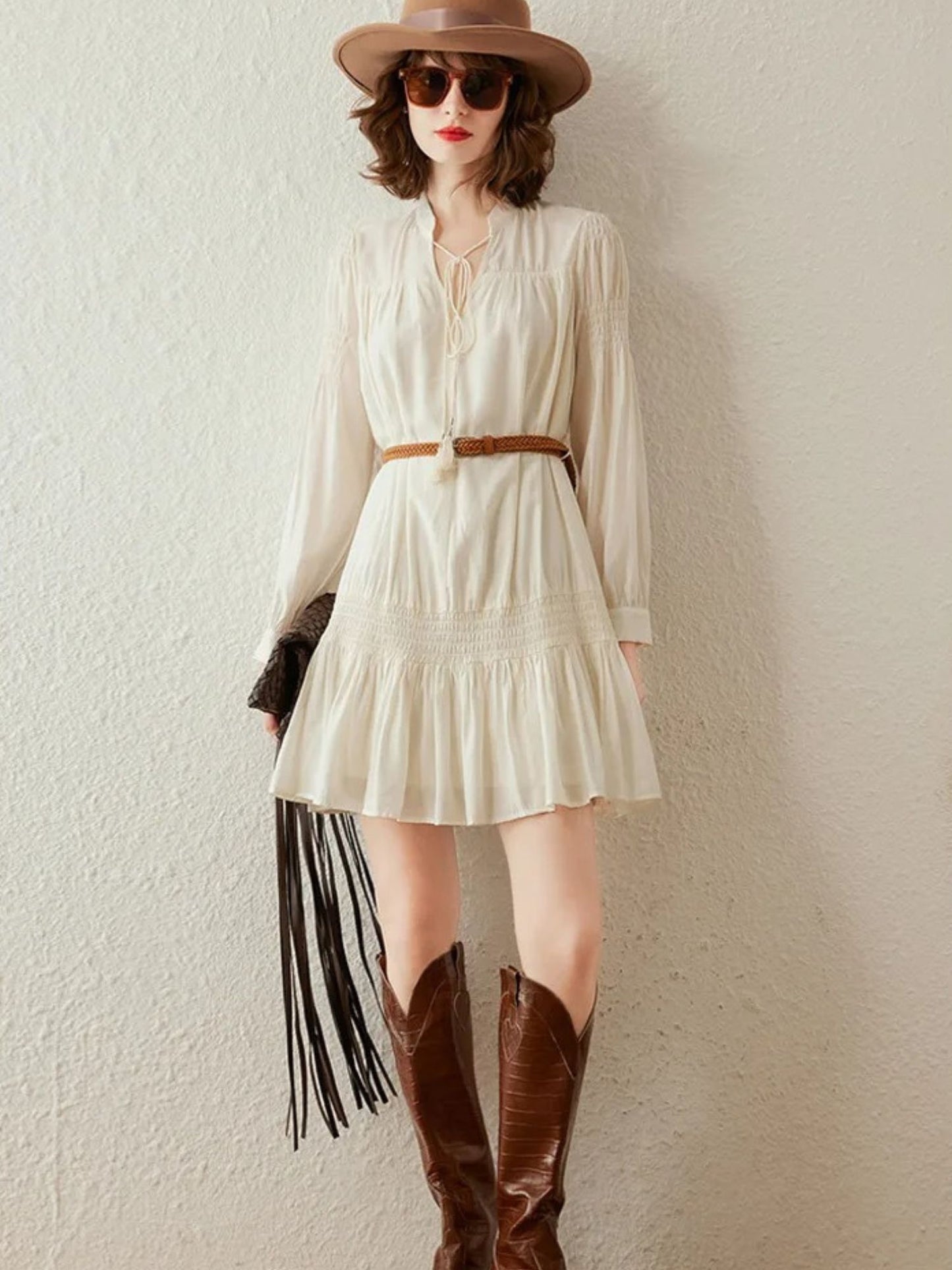 Front view of cream mini dress with braided belt, styled casually