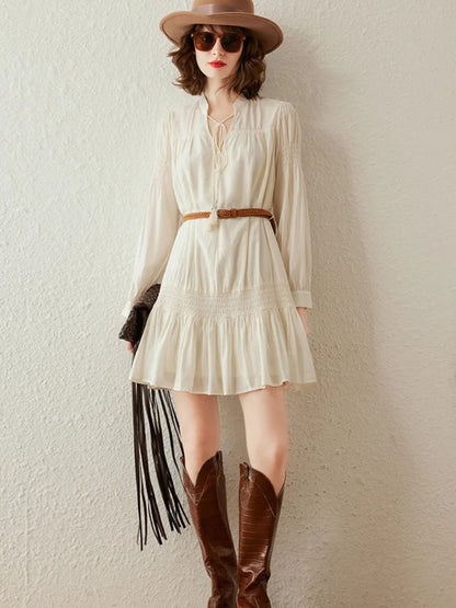 Front view of cream mini dress with braided belt, styled casually