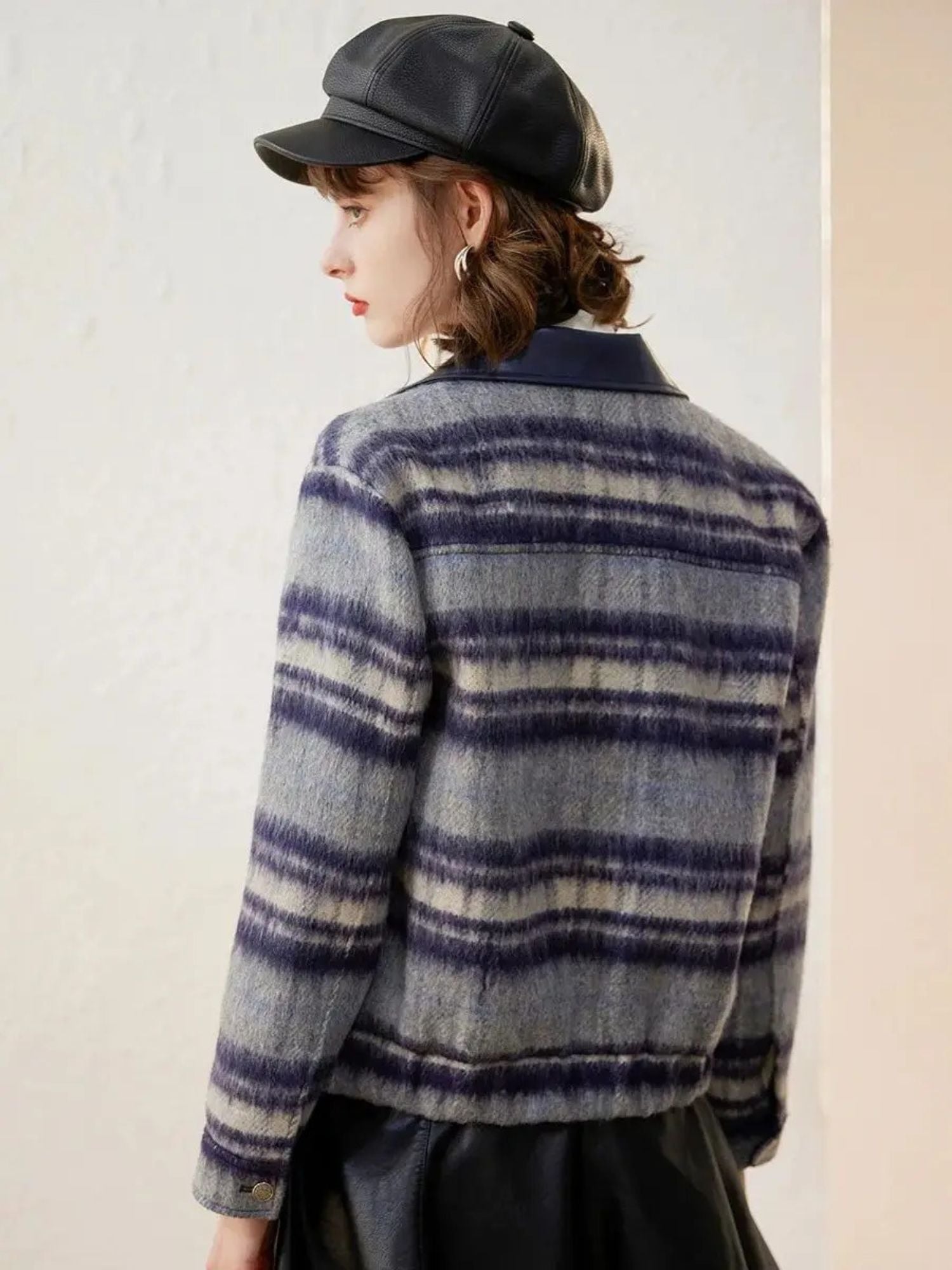 Back view of woman in plaid jacket, showing pattern detail
