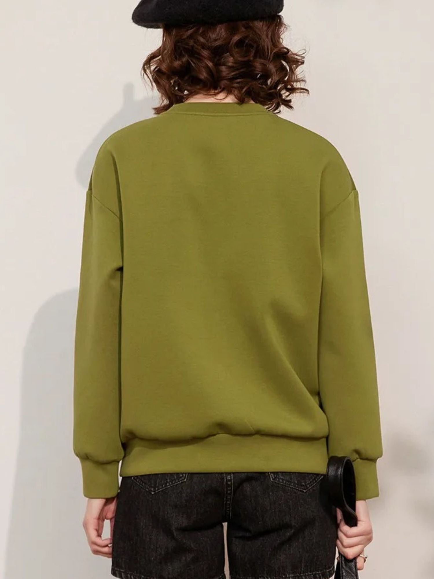Back view of plain green sweatshirt with long sleeves