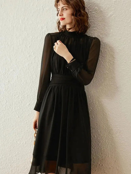 Side angle of black midi dress with sheer pleated fabric