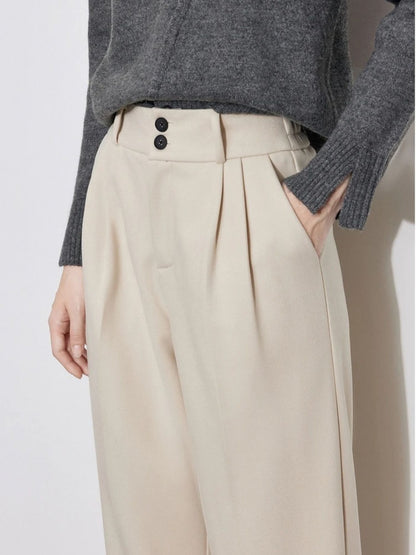 Close-up of ivory wide-leg trousers with waistband and pocket detail