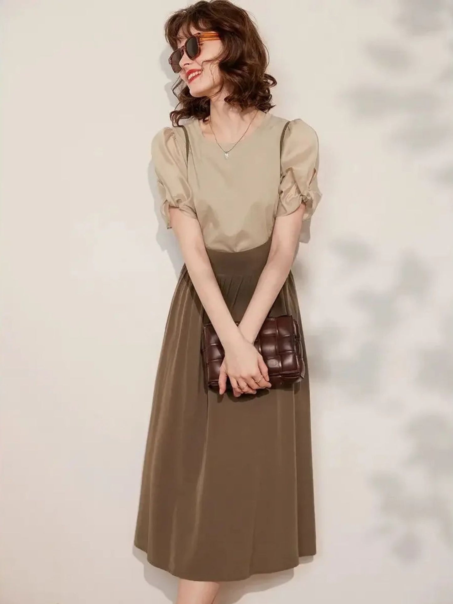 Side angle of beige blouse and brown skirt outfit