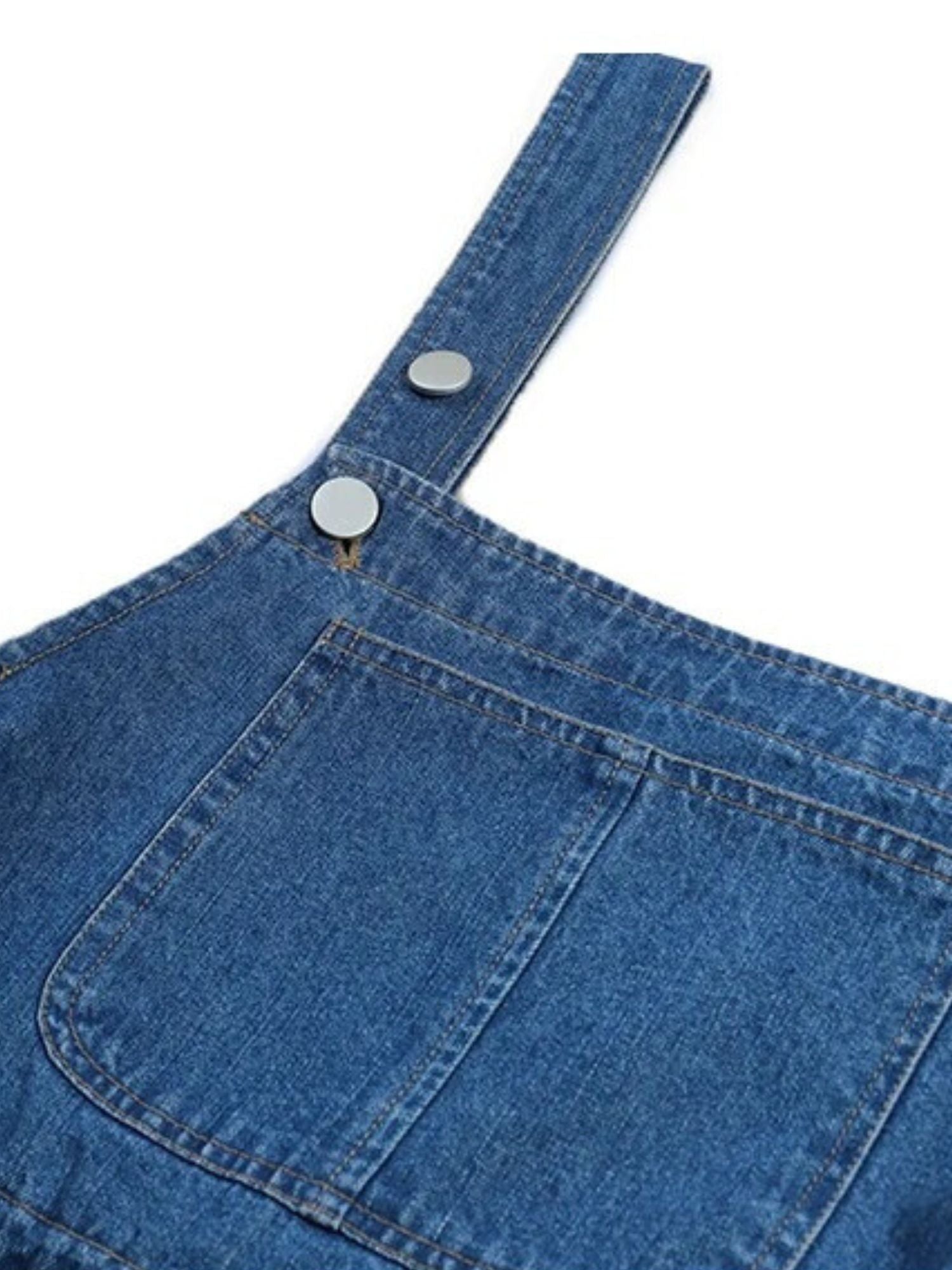 Close-up of denim overall strap with button detail