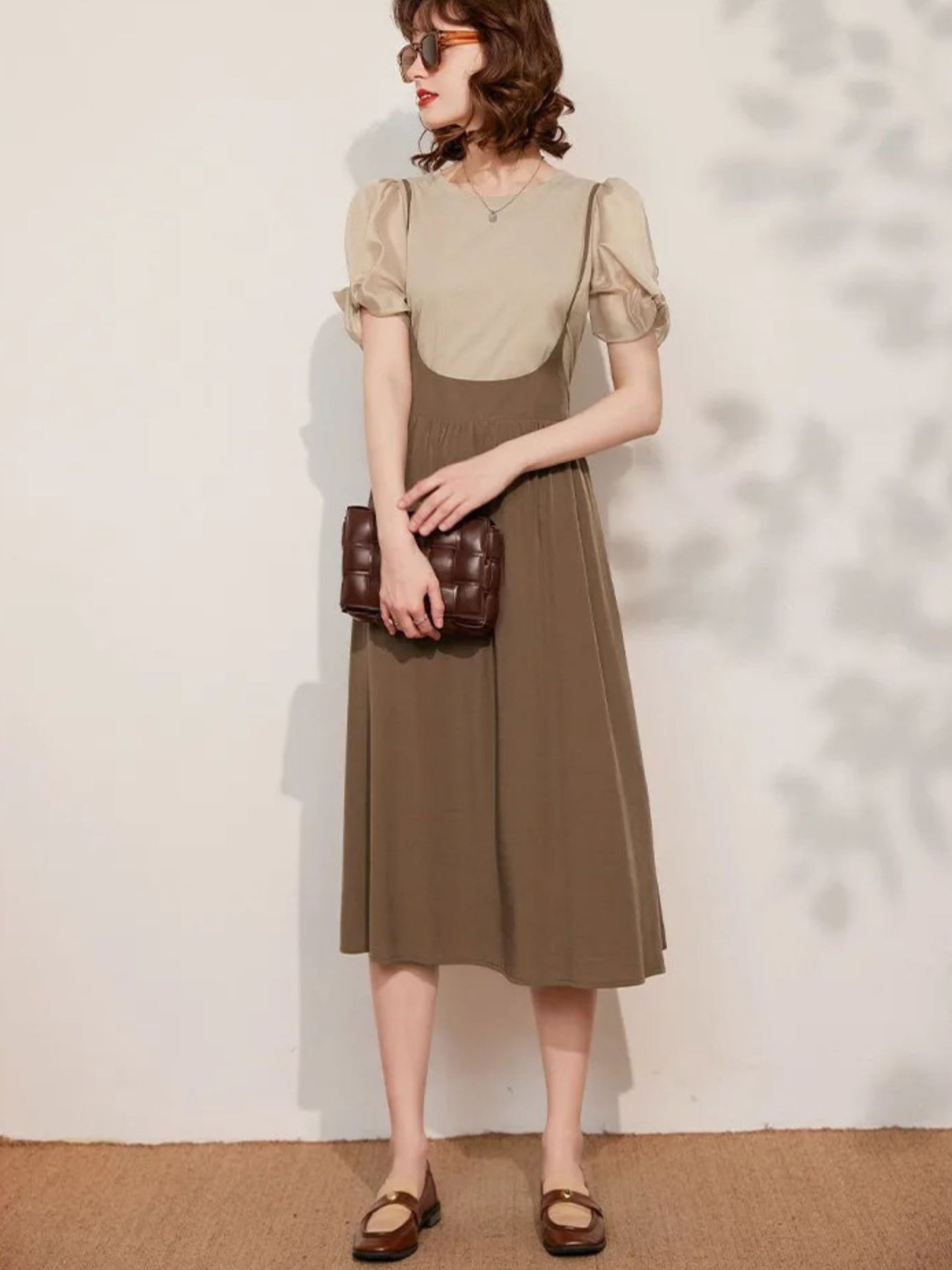 Front view of beige puff-sleeve blouse and brown skirt