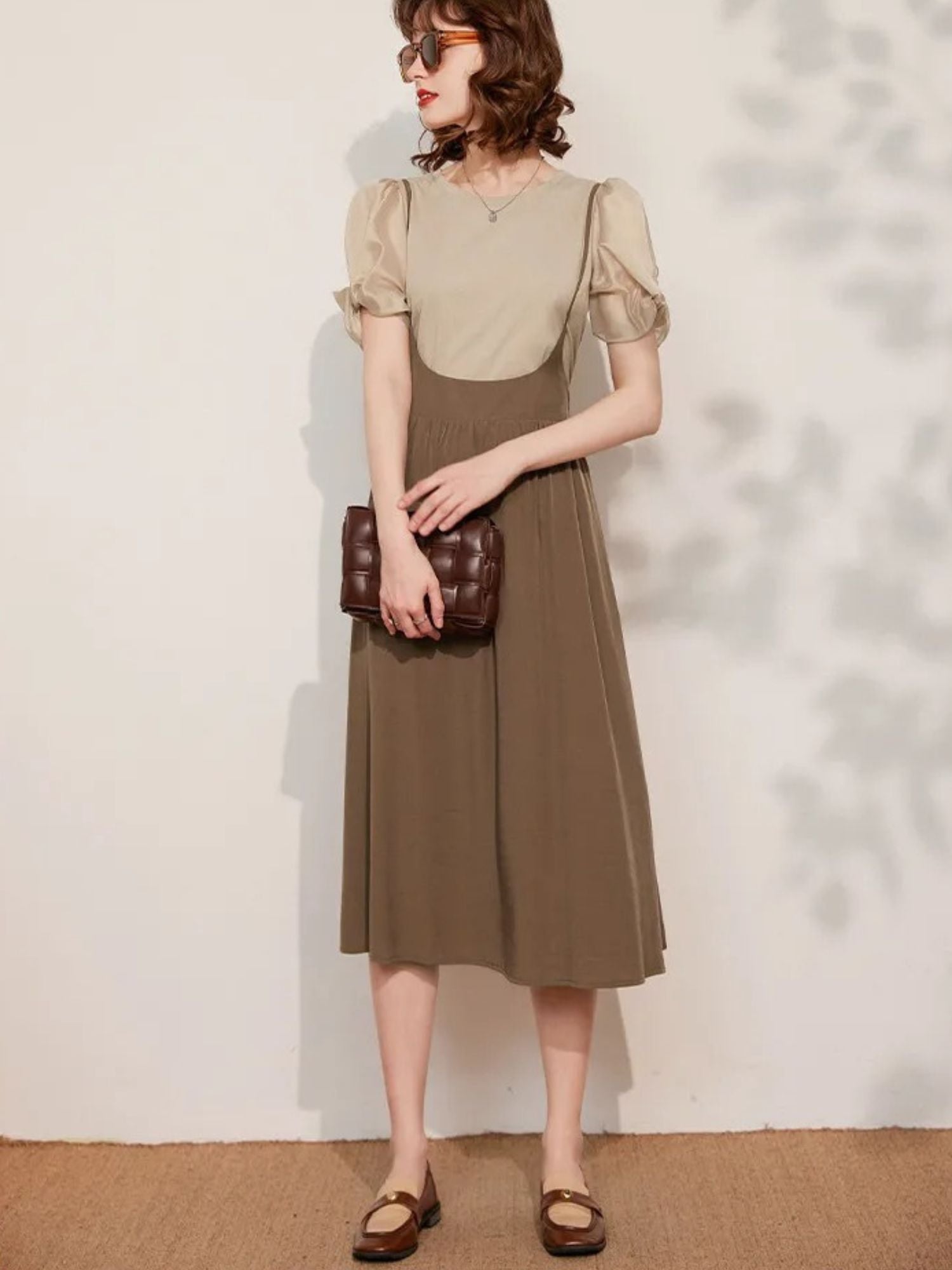 Front view of beige puff-sleeve blouse and brown skirt