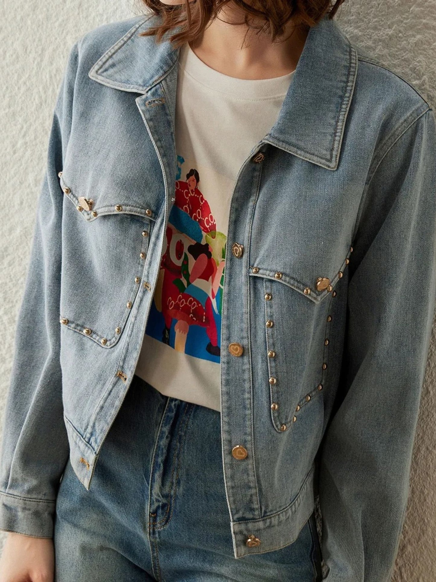 Close up view of the light blue denim jacket and jeans