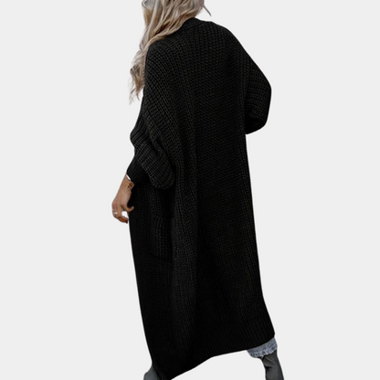 Person wearing a black long cardigan on a white background